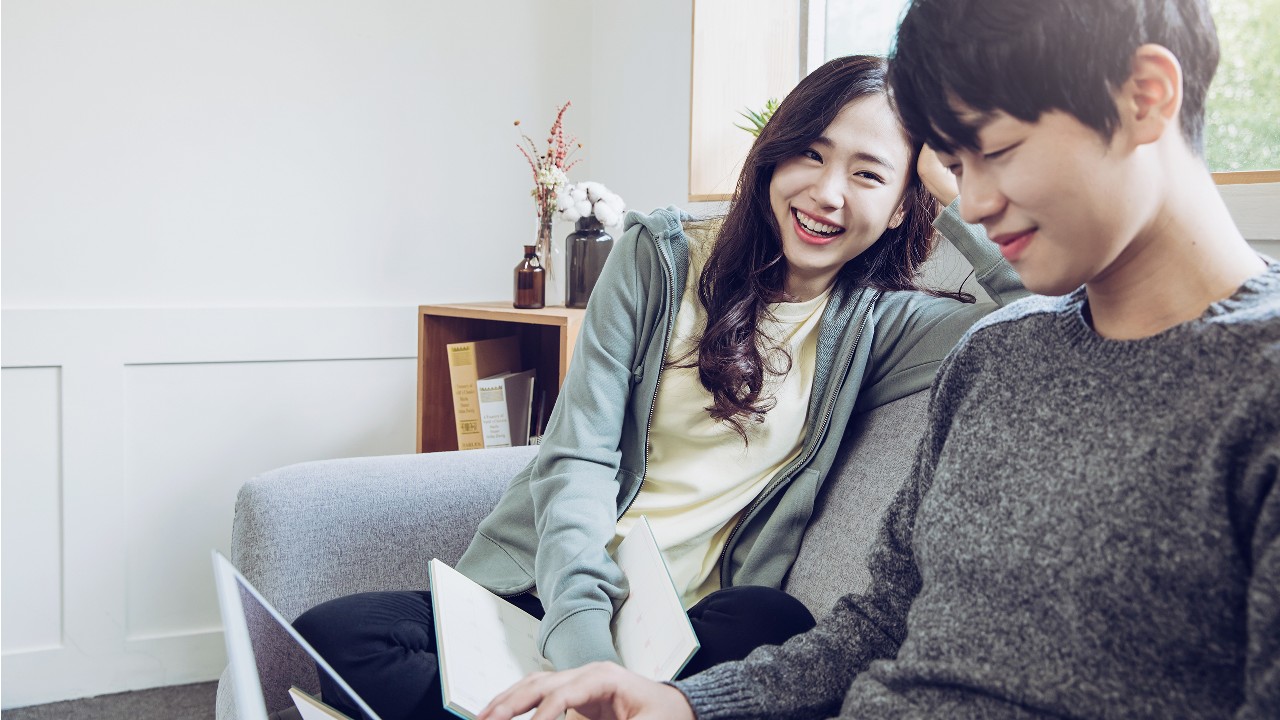Couple is surfing internet at home; image used for HSBC How to get a personal loan for tax payment page.