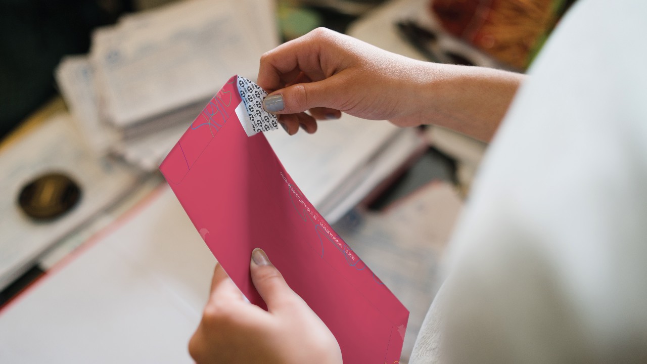 A hand is opening a red envelope; image used for HSBC Taiwan HSBC Co-Brand Credit Cards page.